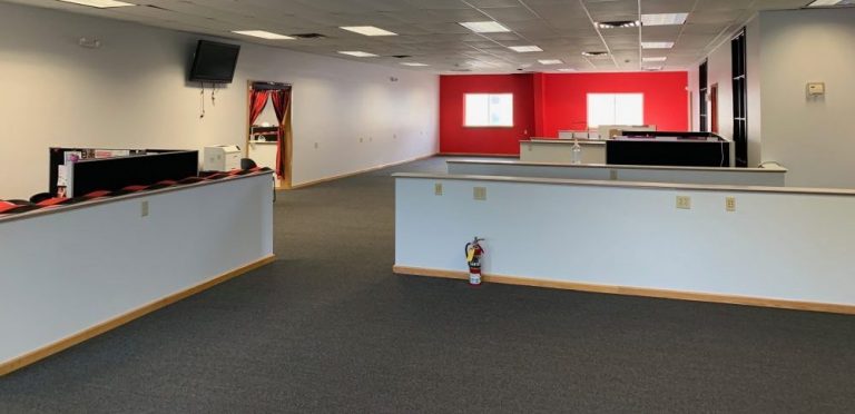Commercial office building with grey carpet and a red wall recently rennovated